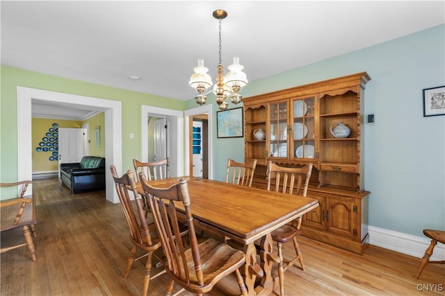 9999 Pierce Rd N, Trenton, NY 13354 - dining area with a baseboard radiator, a chandelier, and light wood finished floors