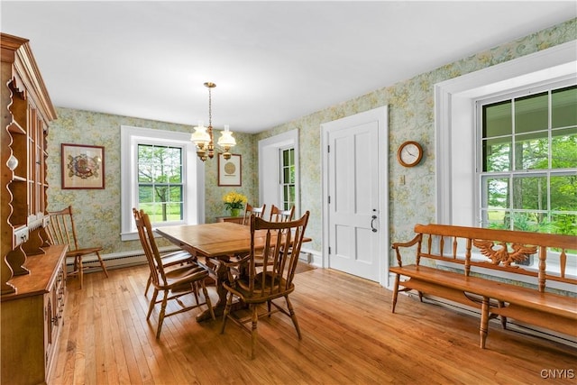 9999 Pierce Rd N, Trenton, NY 13354 - dining room featuring wallpapered walls, light wood-style flooring, a chandelier, and a baseboard heating unit