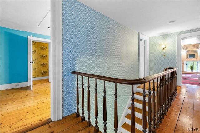 9999 Pierce Rd N, Trenton, NY 13354 - corridor featuring hardwood / wood-style floors, wallpapered walls, and an upstairs landing