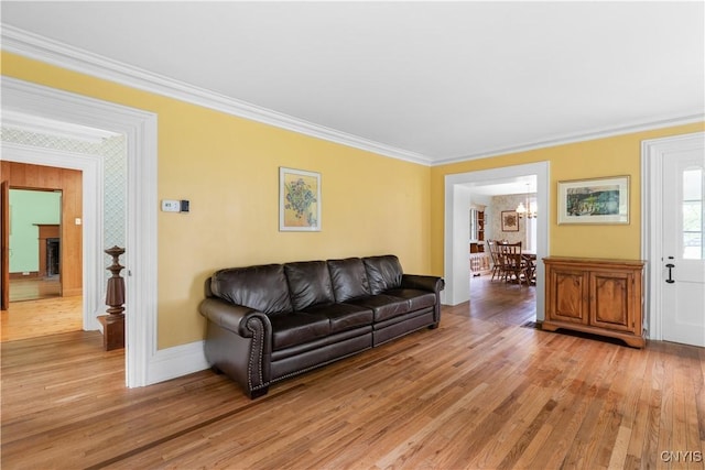 9999 Pierce Rd N, Trenton, NY 13354 - living area featuring ornamental molding, light wood finished floors, and a chandelier