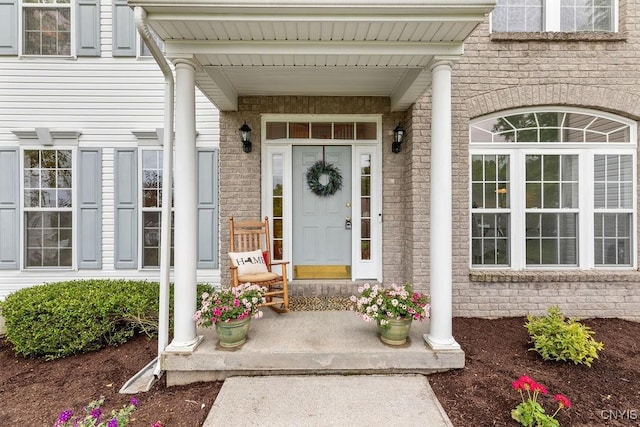 133 Raspberry Ln, Camillus, NY 13031 - property entrance featuring covered porch and brick siding