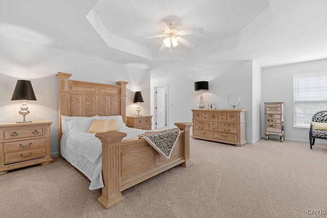 133 Raspberry Ln, Camillus, NY 13031 - bedroom featuring a raised ceiling, light carpet, and a ceiling fan