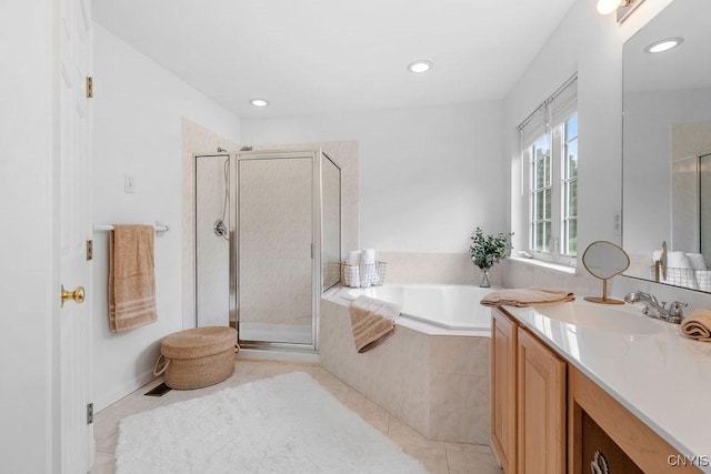133 Raspberry Ln, Camillus, NY 13031 - bathroom featuring vanity, a garden tub, a stall shower, tile patterned floors, and recessed lighting
