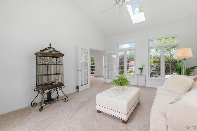 133 Raspberry Ln, Camillus, NY 13031 - carpeted living area with french doors, a skylight, high vaulted ceiling, and ceiling fan