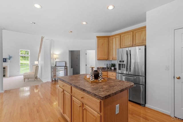 133 Raspberry Ln, Camillus, NY 13031 - kitchen featuring stainless steel fridge with ice dispenser, dark countertops, light wood-type flooring, a center island, and recessed lighting