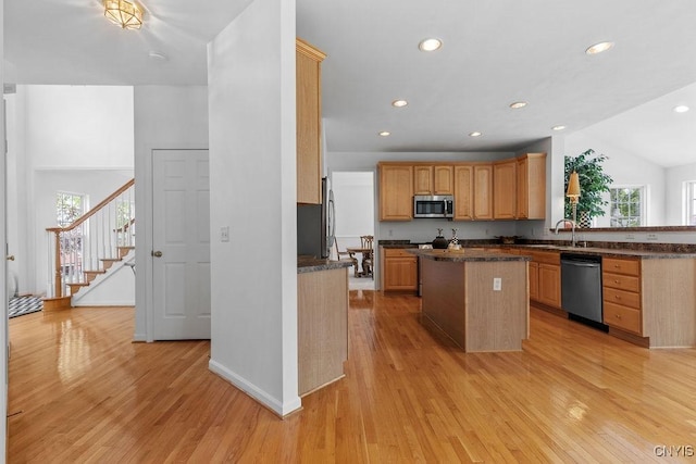 133 Raspberry Ln, Camillus, NY 13031 - kitchen featuring appliances with stainless steel finishes, light wood-type flooring, a kitchen island, recessed lighting, and vaulted ceiling