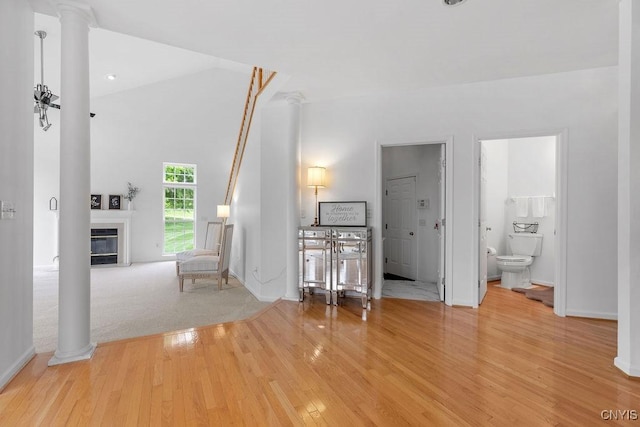133 Raspberry Ln, Camillus, NY 13031 - living room featuring decorative columns, wood finished floors, and a glass covered fireplace