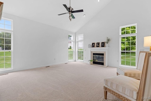 133 Raspberry Ln, Camillus, NY 13031 - living area with high vaulted ceiling, a glass covered fireplace, ceiling fan, carpet floors, and recessed lighting