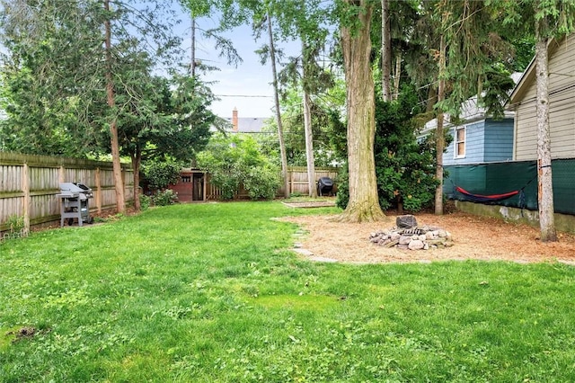 67 Macbeth St, Rochester, NY 14609 - fenced backyard with an outdoor fire pit and a shed