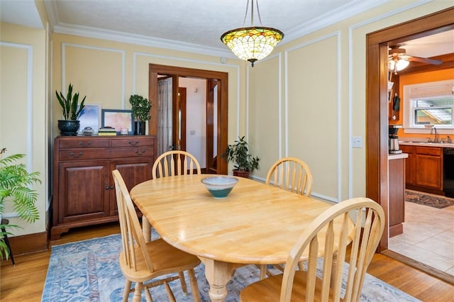 67 Macbeth St, Rochester, NY 14609 - dining area with a decorative wall, light wood-style flooring, and crown molding