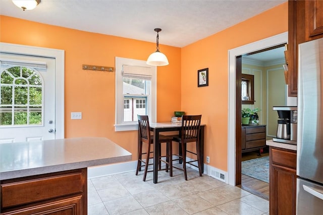 67 Macbeth St, Rochester, NY 14609 - dining space featuring healthy amount of natural light and light tile patterned floors