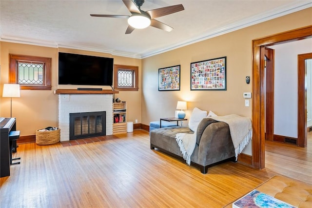 67 Macbeth St, Rochester, NY 14609 - living room featuring wood finished floors, crown molding, a ceiling fan, and a fireplace