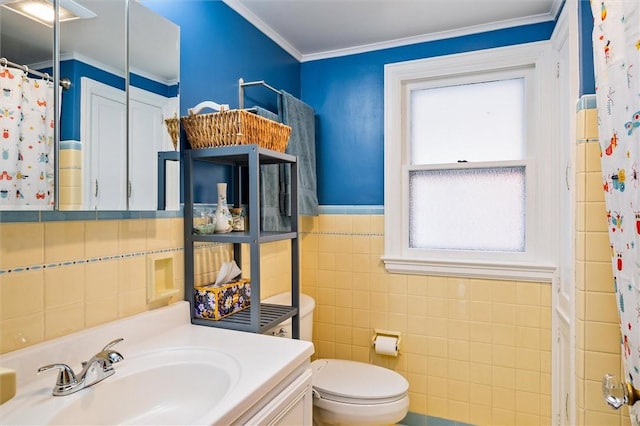 67 Macbeth St, Rochester, NY 14609 - bathroom with vanity, tile walls, ornamental molding, a shower with curtain, and a wainscoted wall