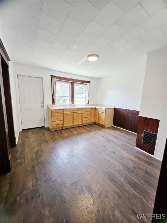 269 Westminster Ave, Buffalo, NY 14215 - unfurnished living room with dark wood-style floors and wainscoting