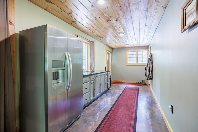 6684 Bishop Rd, Conesus, NY 14435 - kitchen with stainless steel refrigerator with ice dispenser, wooden ceiling, finished concrete flooring, gray cabinetry, and dark countertops