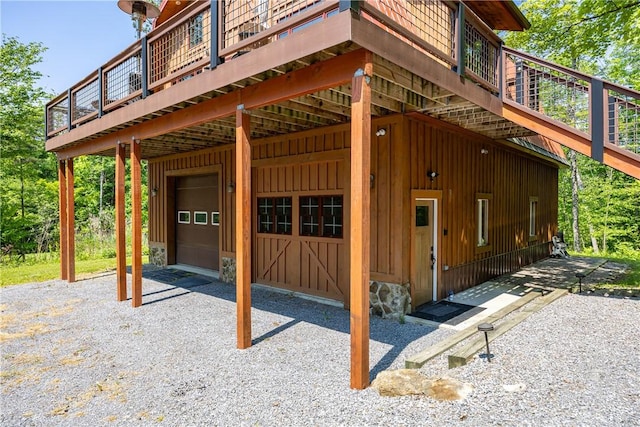 6684 Bishop Rd, Conesus, NY 14435 - view of home's exterior featuring an attached garage, board and batten siding, driveway, and a wooden deck