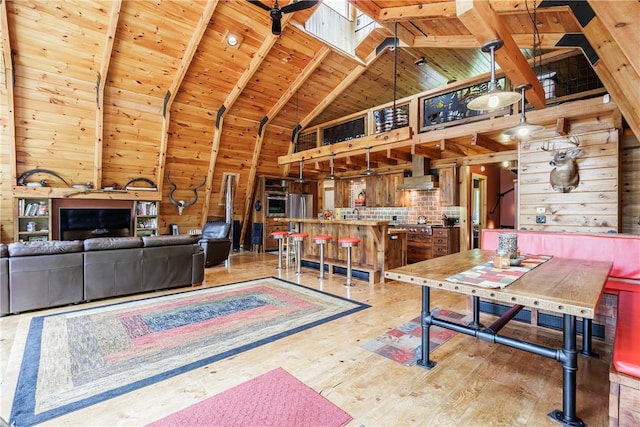 6684 Bishop Rd, Conesus, NY 14435 - living room with a wood ceiling with exposed beams, high vaulted ceiling, light wood-type flooring, and wooden walls