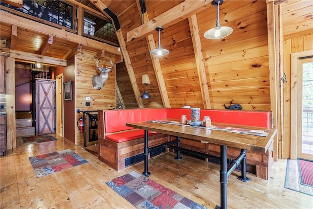 6684 Bishop Rd, Conesus, NY 14435 - dining area with wood walls, hardwood / wood-style floors, healthy amount of natural light, lofted ceiling, and wooden ceiling