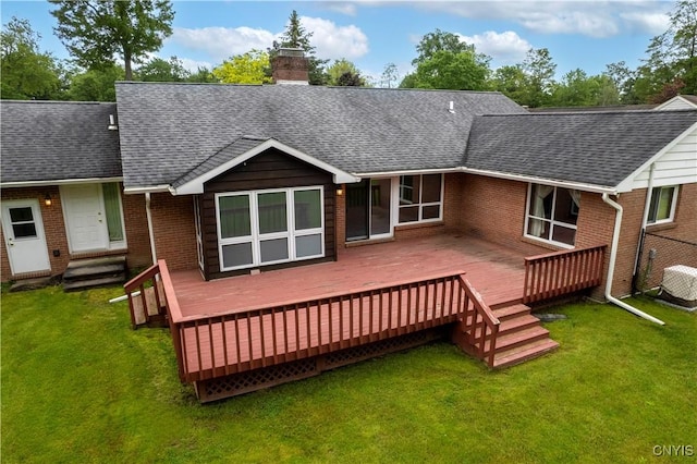 16 Silver Birch Ct, New Hartford, NY 13413 - back of house with roof with shingles, brick siding, a chimney, and a lawn