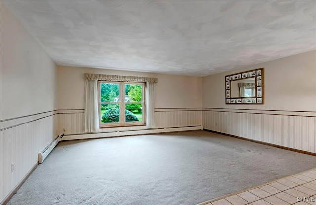 16 Silver Birch Ct, New Hartford, NY 13413 - spare room featuring carpet flooring, a wainscoted wall, and tile patterned floors