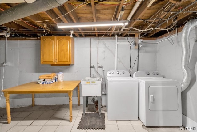 26 Beale Ave, Cheektowaga, NY 14225 - laundry room featuring washer and dryer, cabinet space, and light tile patterned flooring