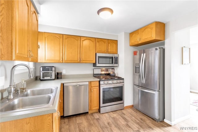 26 Beale Ave, Cheektowaga, NY 14225 - kitchen featuring stainless steel appliances, light wood finished floors, and light countertops