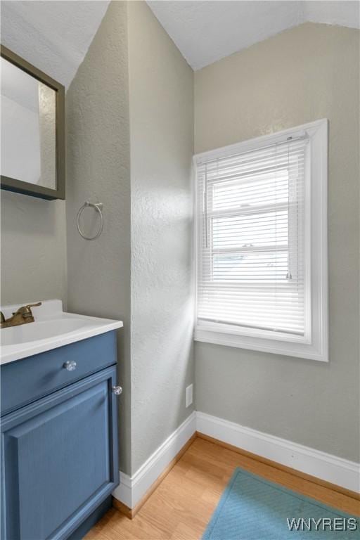 26 Beale Ave, Cheektowaga, NY 14225 - bathroom with wood finished floors, vanity, and lofted ceiling