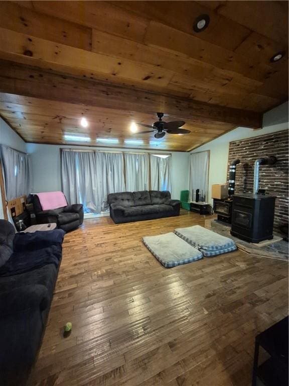 414 Oquaga Lake Rd, Sanford, NY 13754 - living room with a wood stove, ceiling fan, wooden ceiling, hardwood / wood-style floors, and vaulted ceiling