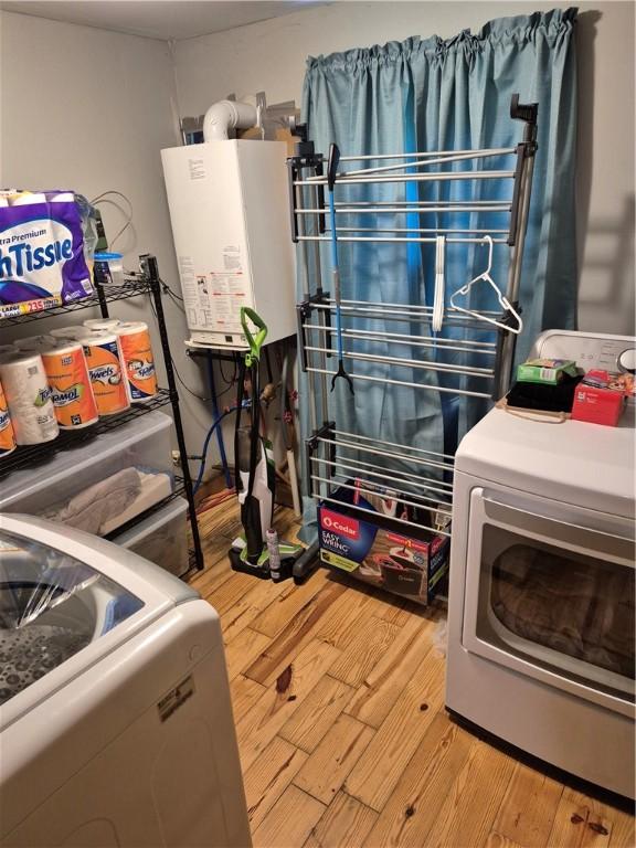 414 Oquaga Lake Rd, Sanford, NY 13754 - laundry room with washer / dryer, gas water heater, and light wood-type flooring