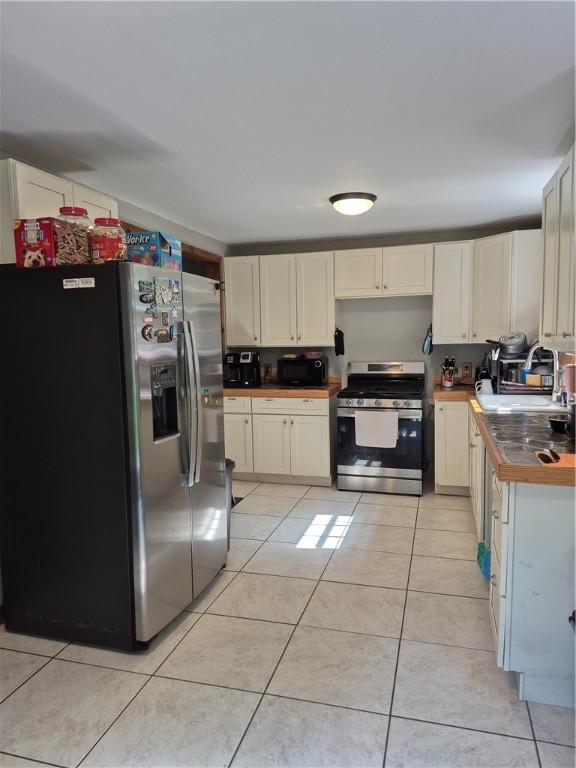 414 Oquaga Lake Rd, Sanford, NY 13754 - kitchen featuring appliances with stainless steel finishes and light tile patterned floors