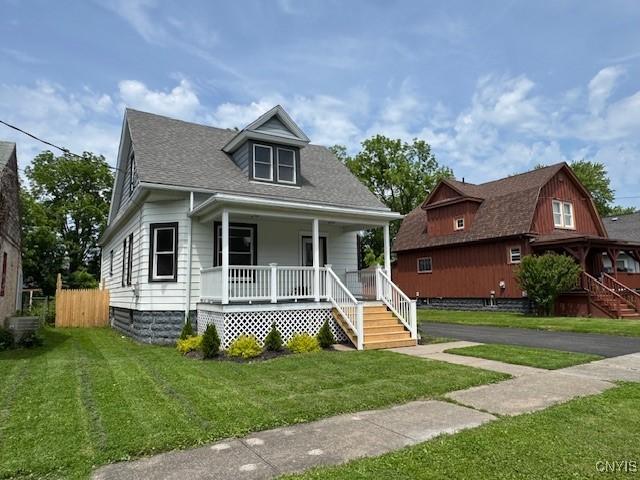 338 Leonard St, Oneida-Inside, NY 13421 - bungalow featuring a porch, a front yard, stairway, and roof with shingles