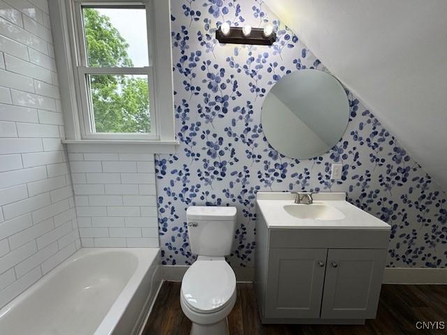 338 Leonard St, Oneida-Inside, NY 13421 - bathroom with wallpapered walls, wood finished floors, a tub, and plenty of natural light