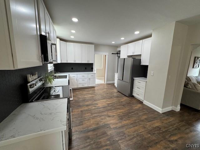 338 Leonard St, Oneida-Inside, NY 13421 - kitchen with stainless steel appliances, dark wood finished floors, recessed lighting, white cabinets, and light stone countertops