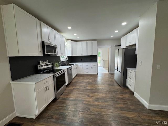338 Leonard St, Oneida-Inside, NY 13421 - kitchen with stainless steel appliances, dark wood finished floors, white cabinets, recessed lighting, and light countertops