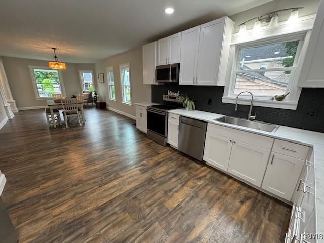 338 Leonard St, Oneida-Inside, NY 13421 - kitchen with appliances with stainless steel finishes, dark wood finished floors, plenty of natural light, white cabinetry, and recessed lighting