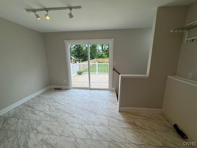 338 Leonard St, Oneida-Inside, NY 13421 - spare room with rail lighting and light marble finish floors