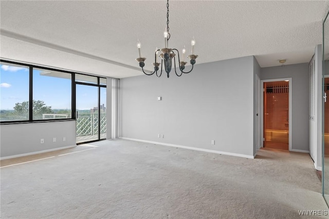 1088 Delaware Ave Unit 9I, Buffalo, NY 14209 - empty room featuring a textured ceiling, a chandelier, and carpet floors