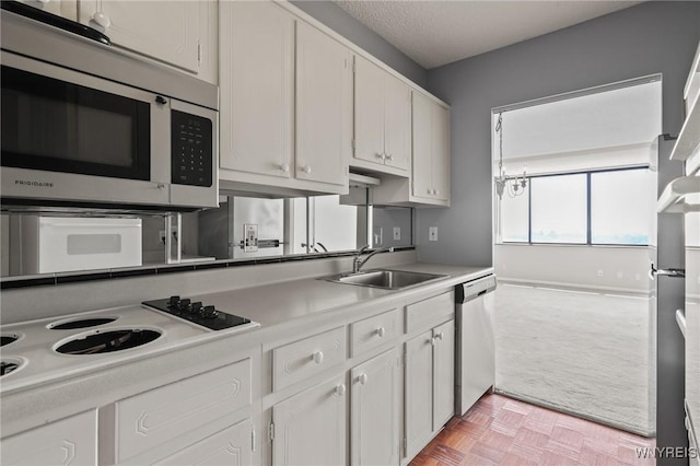 1088 Delaware Ave Unit 9I, Buffalo, NY 14209 - kitchen with stainless steel appliances, light colored carpet, white cabinets, and light countertops