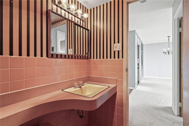 1088 Delaware Ave Unit 9I, Buffalo, NY 14209 - bathroom with wallpapered walls and a chandelier