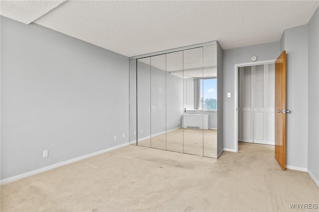 1088 Delaware Ave Unit 9I, Buffalo, NY 14209 - unfurnished bedroom with carpet, a textured ceiling, and radiator heating unit