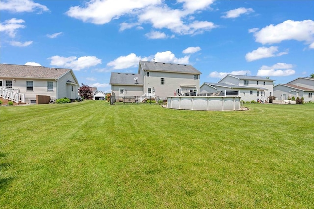 16 Leah Ln, Chili, NY 14514 - rear view of house with a lawn and a covered pool