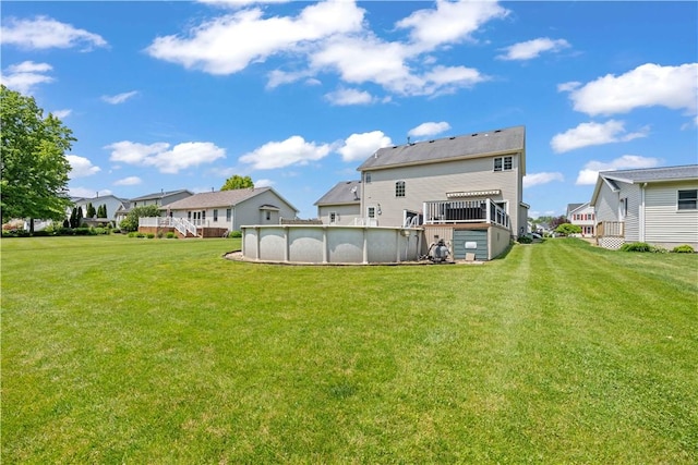 16 Leah Ln, Chili, NY 14514 - rear view of house featuring a wooden deck, an outdoor pool, a residential view, and a lawn