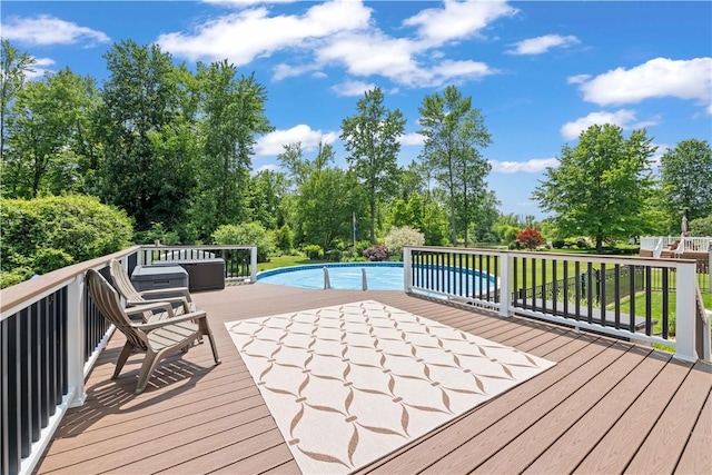 16 Leah Ln, Chili, NY 14514 - wooden deck with an outdoor pool and view of scattered trees