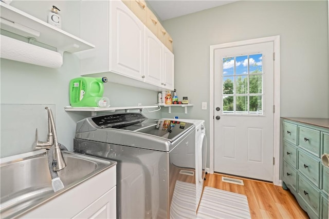 16 Leah Ln, Chili, NY 14514 - washroom featuring washing machine and dryer, cabinet space, and light wood finished floors
