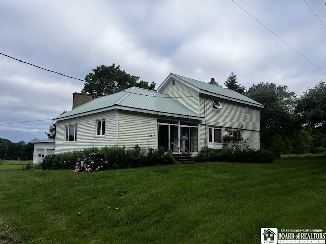 4871 Bayview Rd, Ellery, NY 14712 - view of front of home featuring a chimney, a front lawn, a metal roof, and a garage