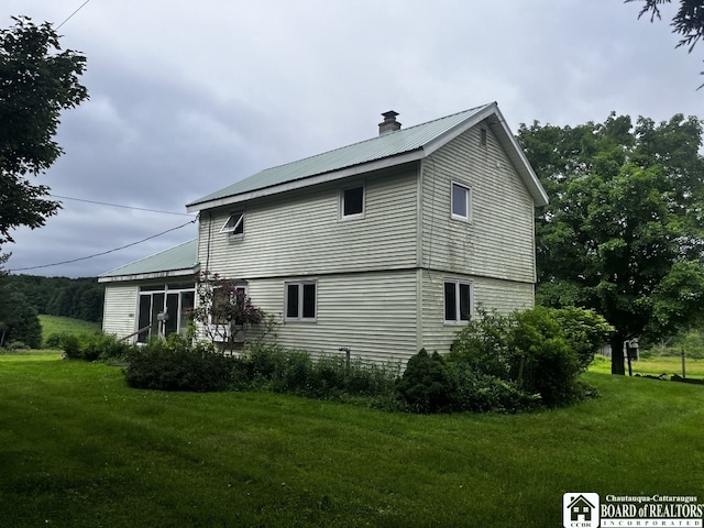 4871 Bayview Rd, Ellery, NY 14712 - view of side of property featuring a chimney, a lawn, and a metal roof