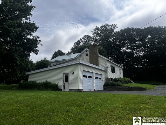 4871 Bayview Rd, Ellery, NY 14712 - view of side of property with a chimney, a yard, and an attached garage