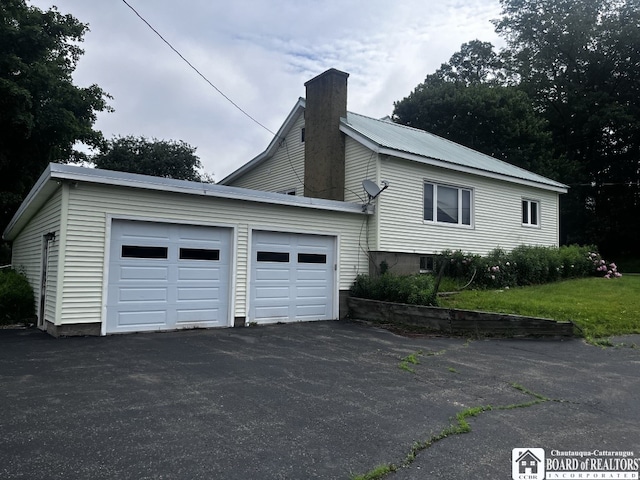 4871 Bayview Rd, Ellery, NY 14712 - view of side of home featuring a chimney, driveway, and a garage