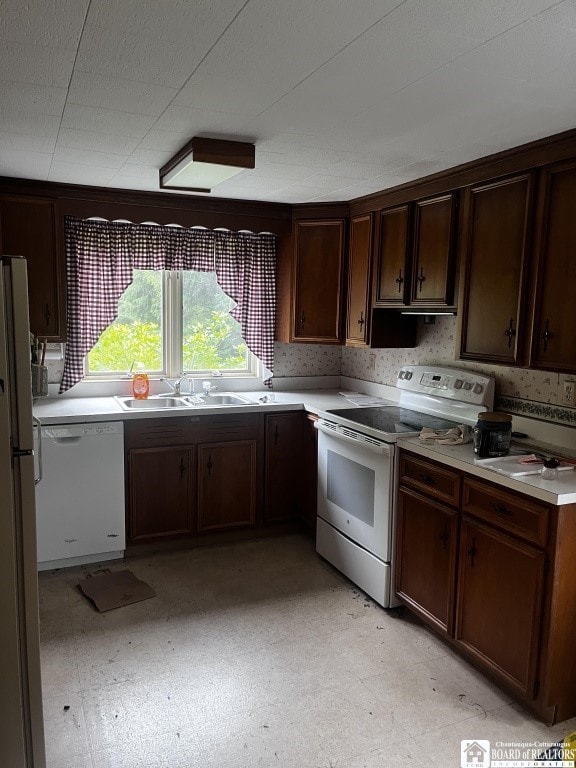 4871 Bayview Rd, Ellery, NY 14712 - kitchen with white appliances, light countertops, light flooring, and dark brown cabinetry