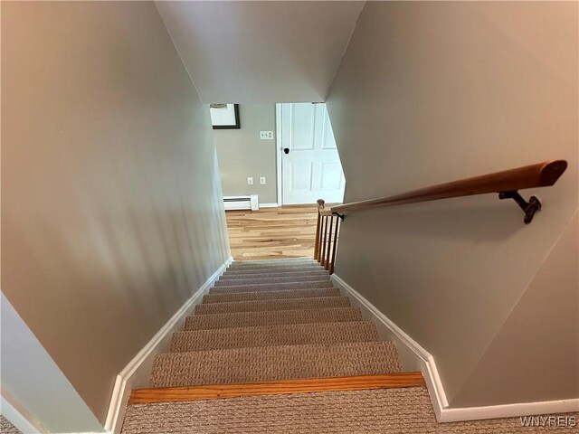 4214 Wilson Burt Rd, Wilson, NY 14172 - stairway featuring baseboard heating and wood finished floors